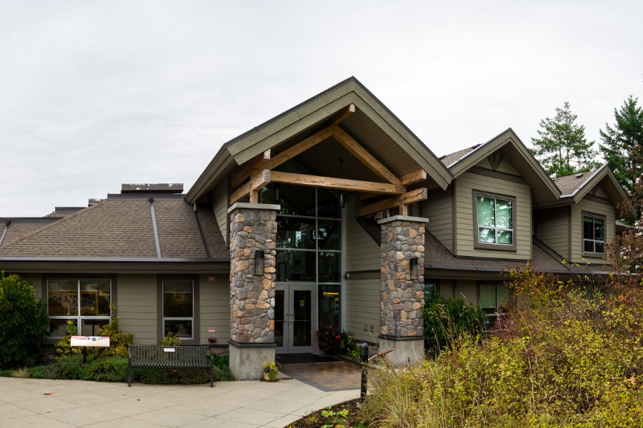 Jeneece Place, designed by Alan Lowe Architecture, contemporary house with wood and stone features, and neutral siding colours. 