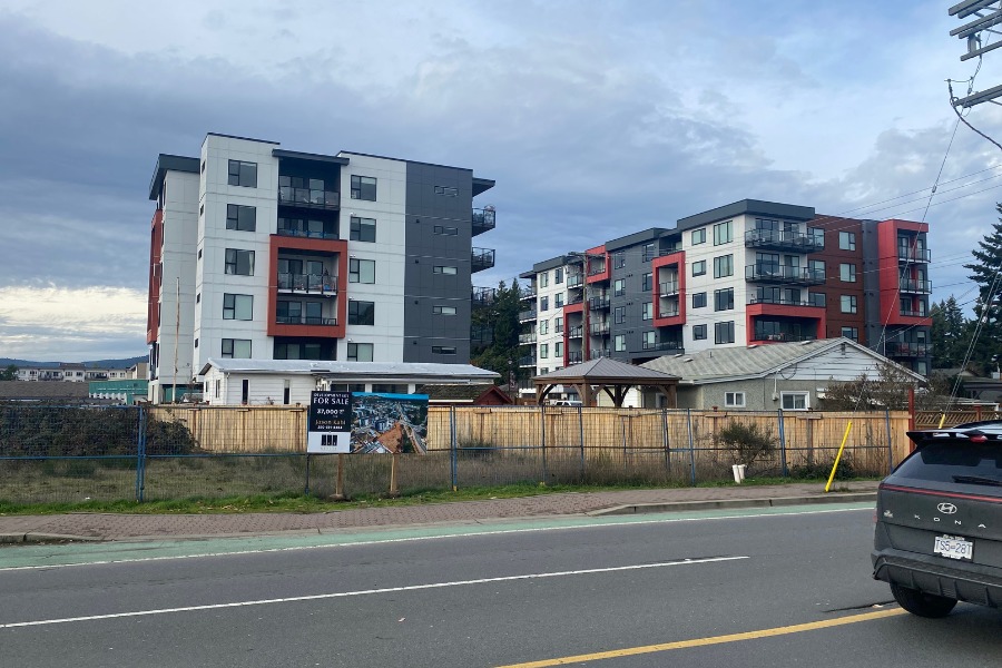 The Trilogy buildings, designed by Alan Lowe Architecture, in blue grey and red.