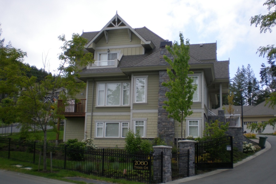 Troon Court Townhouse in a traditionally modern style with stonework and lighter coloured siding.